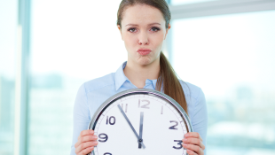 Businesswoman holding clock