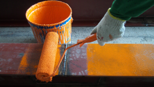 Paint roller with orange paint