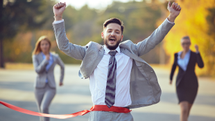 Businessman crossing finish line