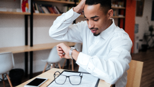 Businessman looking at watch