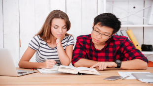 Woman and man reading book together