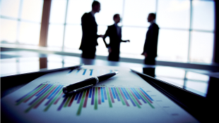 Business people discussing with trends chart on table