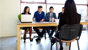 Businesswoman sitting in front of panel