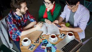 People around table drinking coffee