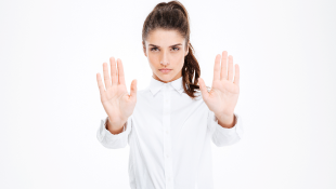 Woman with hands up in stop, warning