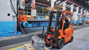 Forklift driving through manufacturing site