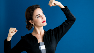 Businesswoman showing arm strength