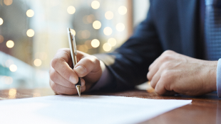 Businessman signing document