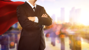 Businessman with cape in superhero pose