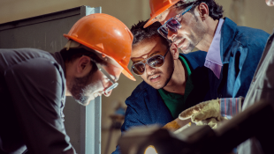 Workers using industrial machinery