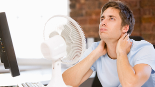 Man in front of fan