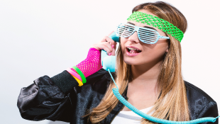 Woman in 1980s fashion and old-fashioned phone