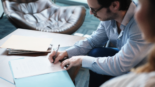 Businessman signing document