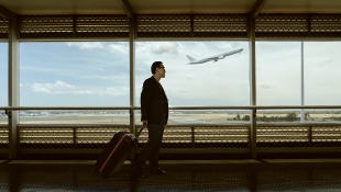 Man traveling through airport terminal