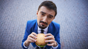 Businessman holding burger