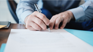 Businessman signing document