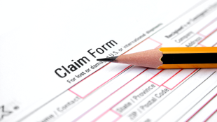 Pencil lying on claim form