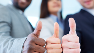 Three businessmembers with thumbs up