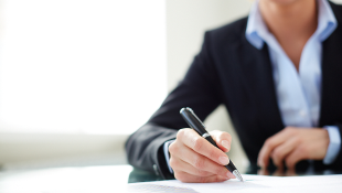 Businesswoman signing document